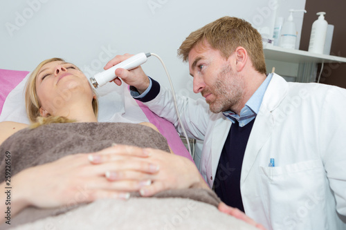 carrying an ultrasound test on female patient photo