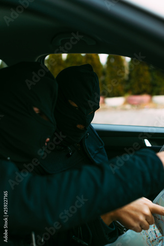 Wall Mural bank robbers putting their mask on prepared to do their next robbery,checking and loading their guns