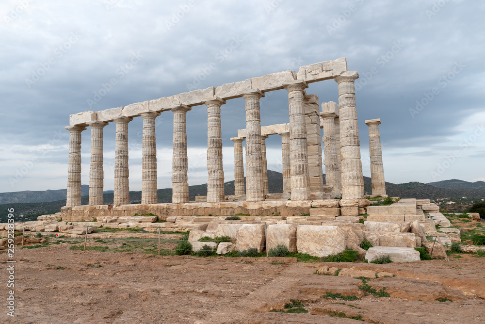 Fototapeta premium Greek temple vertical columns stone marble cliff