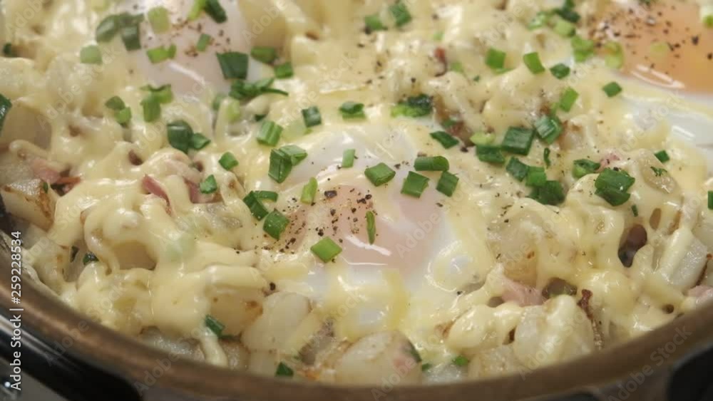 Homemade cooking eggs with cheese and herbs on pan for breakfast, close up food video. Homemade cooking eggs with cheese and herbs on pan for breakfast, close up food video.