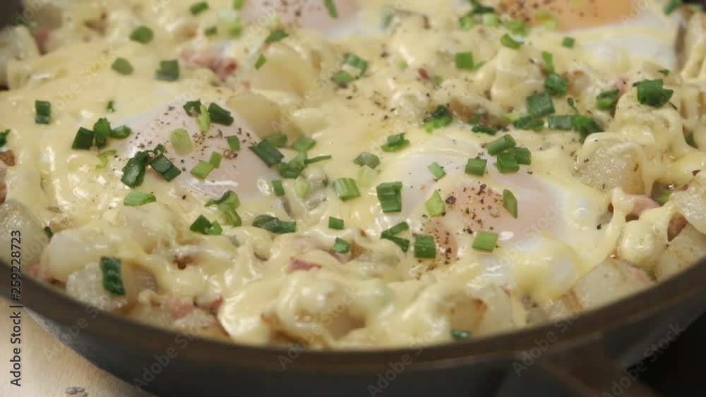 Homemade cooking breakfast with eggs, bacon, cheese and herbs on pan for breakfast, close up food video. Homemade cooking breakfast with eggs, bacon, cheese and herbs on pan for breakfast, close up food video.