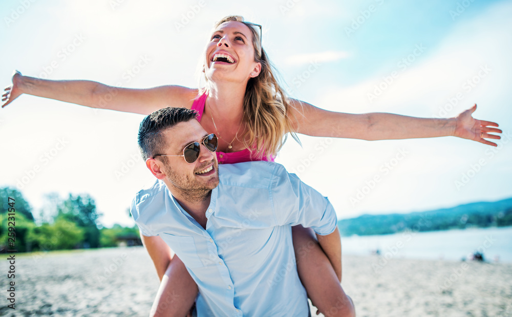 Couple having fun on the beach. Lifestyle, love, dating, vacation concept Couple having fun on the beach. Lifestyle, love, dating, vacation concept