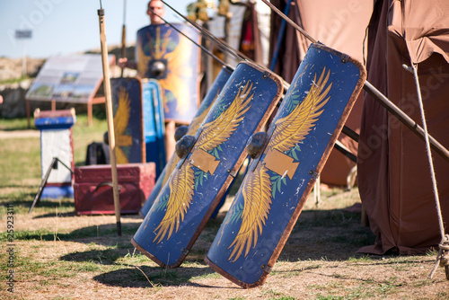 Medieval shields in a row. Weapons prepared for fight, battle of war. Reenactment festival in summer in Romania. 