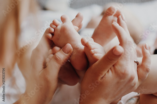 Mother holding twin babies feet
