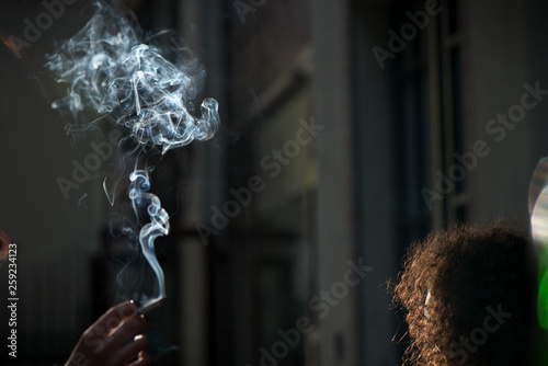 Minors smoking in a public venue, discussing the regulation of tobacco and other psychedelic substances. Smokers causing second hand smoking. Concept of unhealthy habits and living. Having discussion 