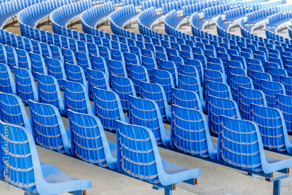 Fototapeta premium Rows of blue plastic chairs on a metal base in rows around the circle in the hall for business presentations