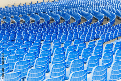 Blue plastic chairs arranged in rows around the circle in the hall for business presentations