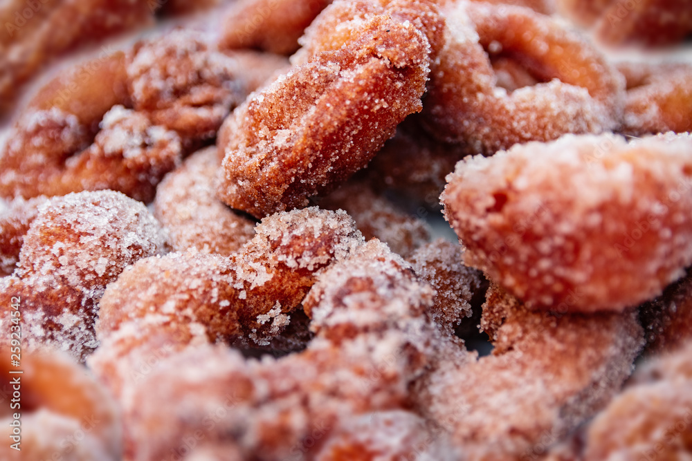 Multiple homemade doughnuts coated with sugar Multiple homemade doughnuts coated with sugar