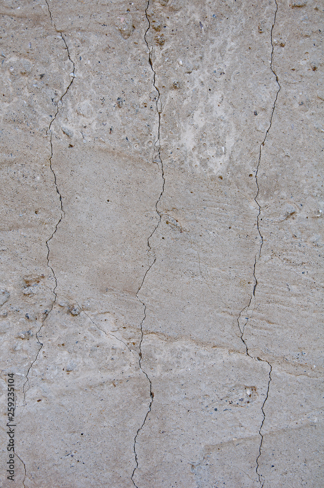 Gray concrete texture background. Damage. Cracked stone wall background.
