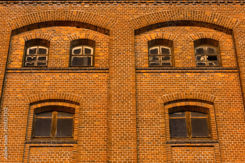 Dirty and broken windows of the old mill building