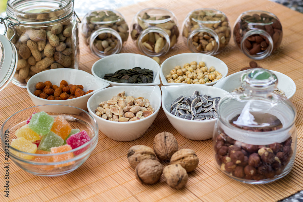 Various piles of mixed gummy candy and nuts 