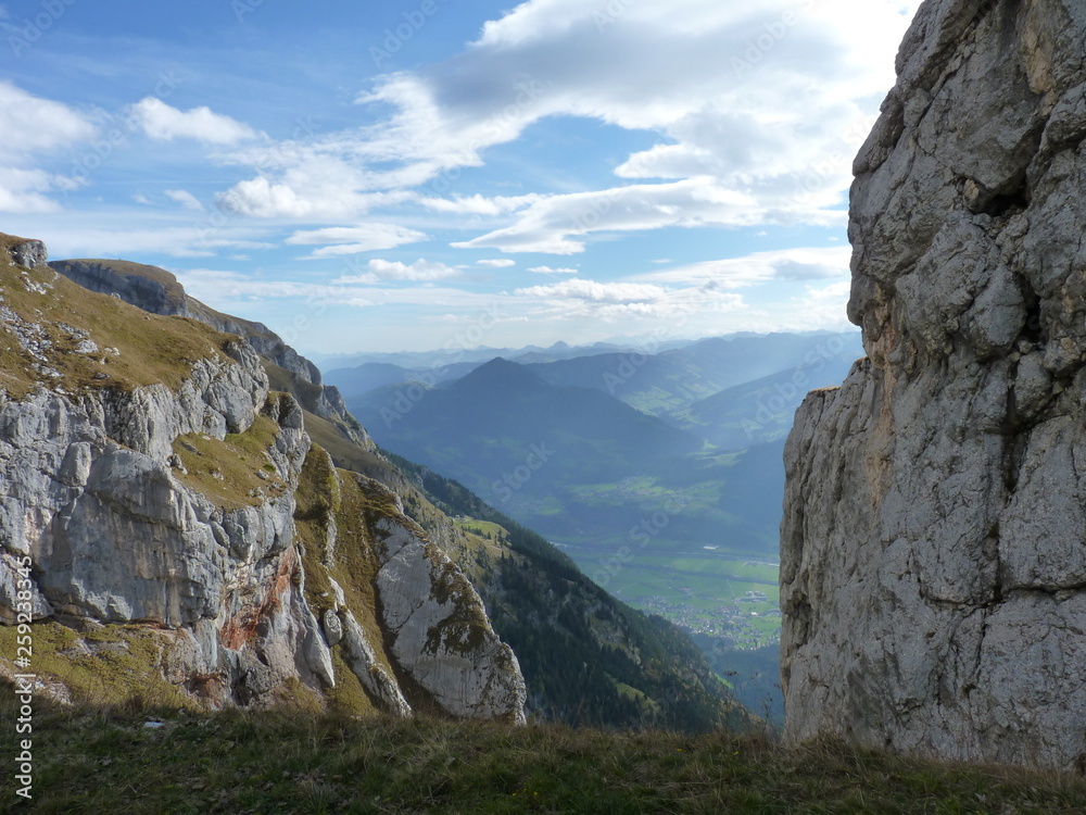 Obraz premium Heavy Clouds blending with the mountain peaks