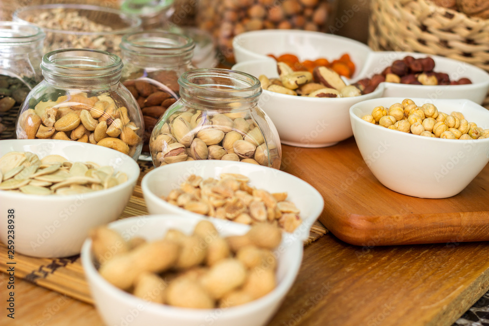 Various piles of mixed nuts and seeds Various piles of mixed nuts and seeds