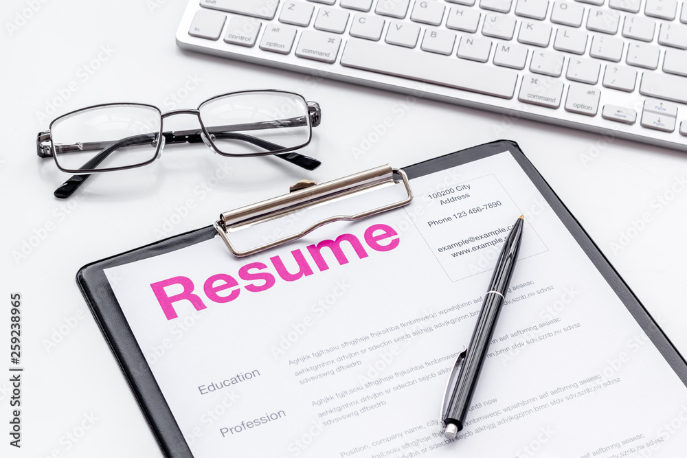 Create CV concept with pen, glasses, keyboard on white desk top view Create CV concept with pen, glasses, keyboard on white desk top view