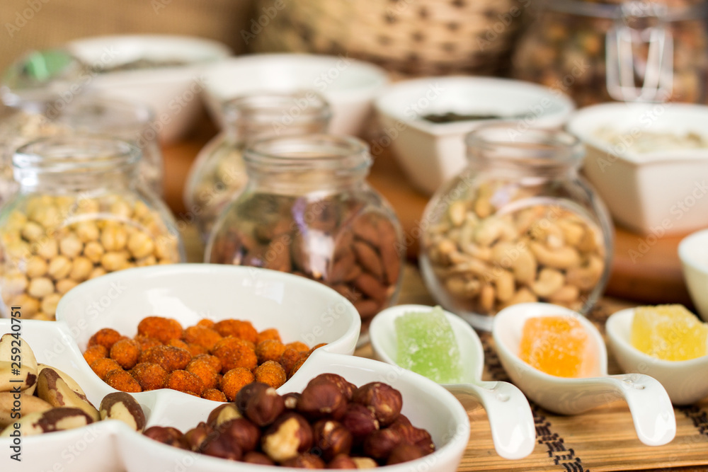 Various piles of mixed gummy candy and nuts 