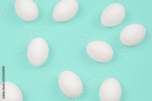 White egg. Raw eggs on pastel green background.