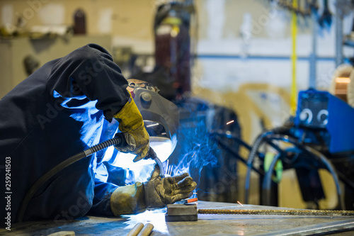 Welder in a blacksmith shop photo