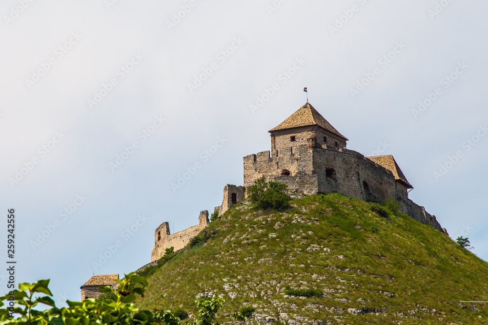Ancient knight's castle on a hill (Hungary) on a background of gloomy sky