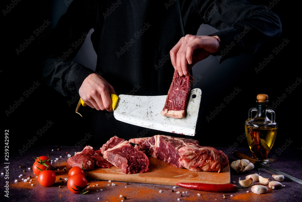 Butcher cuts fresh meat on the wood board.Beef steak and salt on background with free space for text design or logotype menu restaurant.