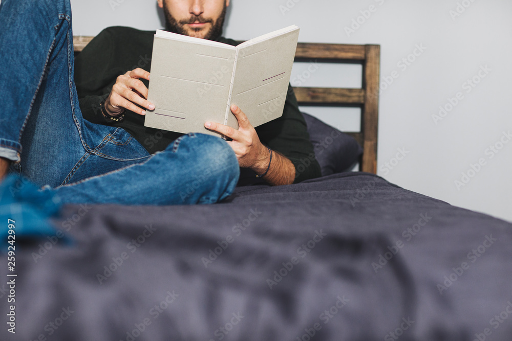 A Man Reading a Book at Home A Man Reading a Book at Home