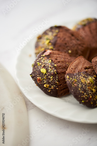 Chocolate Madeleine with pistachion nuts. photo