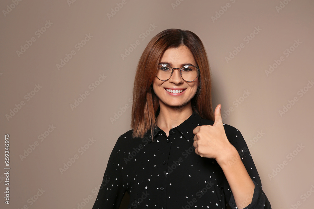 Woman showing THUMB UP gesture in sign language on color background, space for text Woman showing THUMB UP gesture in sign language on color background, space for text