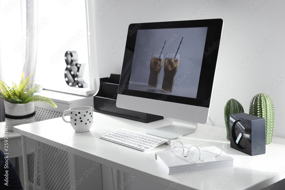 Comfortable workplace with computer on desk in home office Comfortable workplace with computer on desk in home office