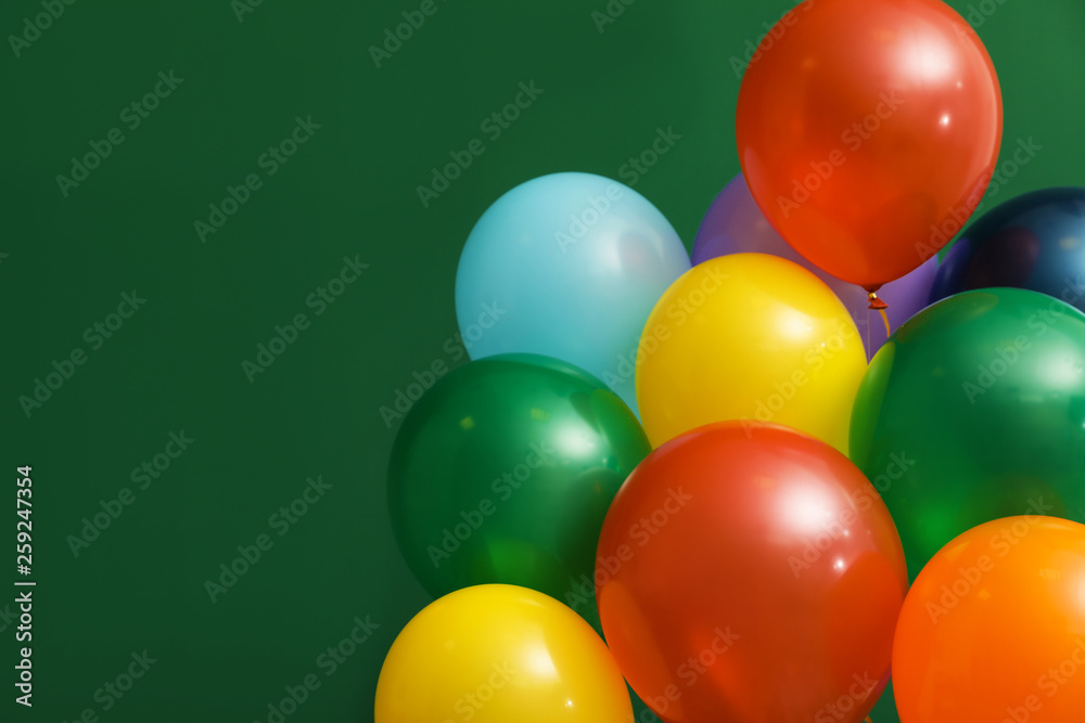 Bunch of bright balloons on color background, space for text. Celebration time