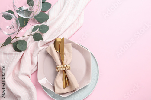 Stylish elegant table setting on color background, top view. Space for text