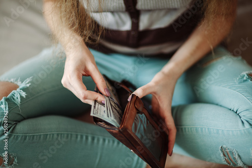 Anonymous woman counting new modern hundred dollar bills