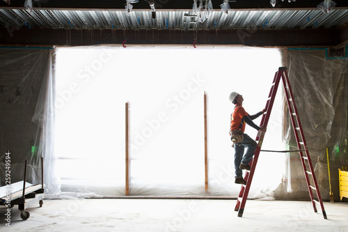 Construction worker on ladder