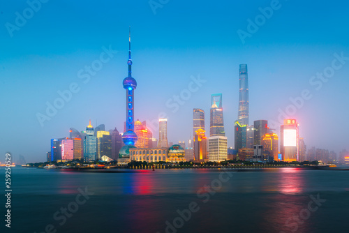 Shanghai, China city skyline at night on the Huangpu River.