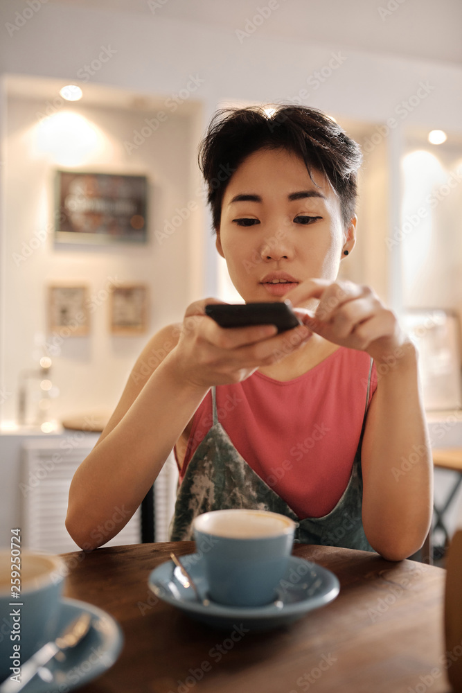 Woman taking picture of coffee