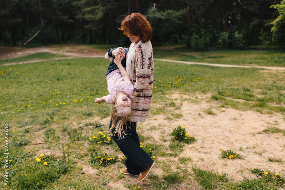 Mother and daughter playing __ the forest glade Mother and daughter playing __ the forest glade