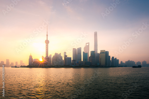 Shanghai, China city skyline during sunrise on the Huangpu River.