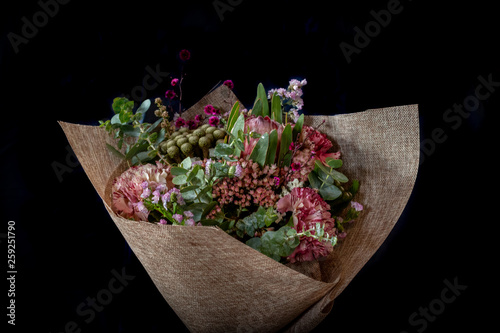 Beautiful Australian native flower arrangement wrapped bouquet Eucalyptus, protea, bush flowers, carnation with black background