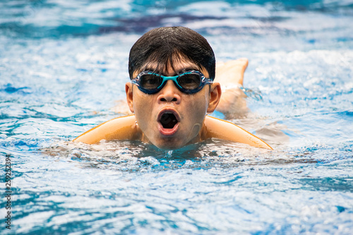 Asian man swimming in the pool.