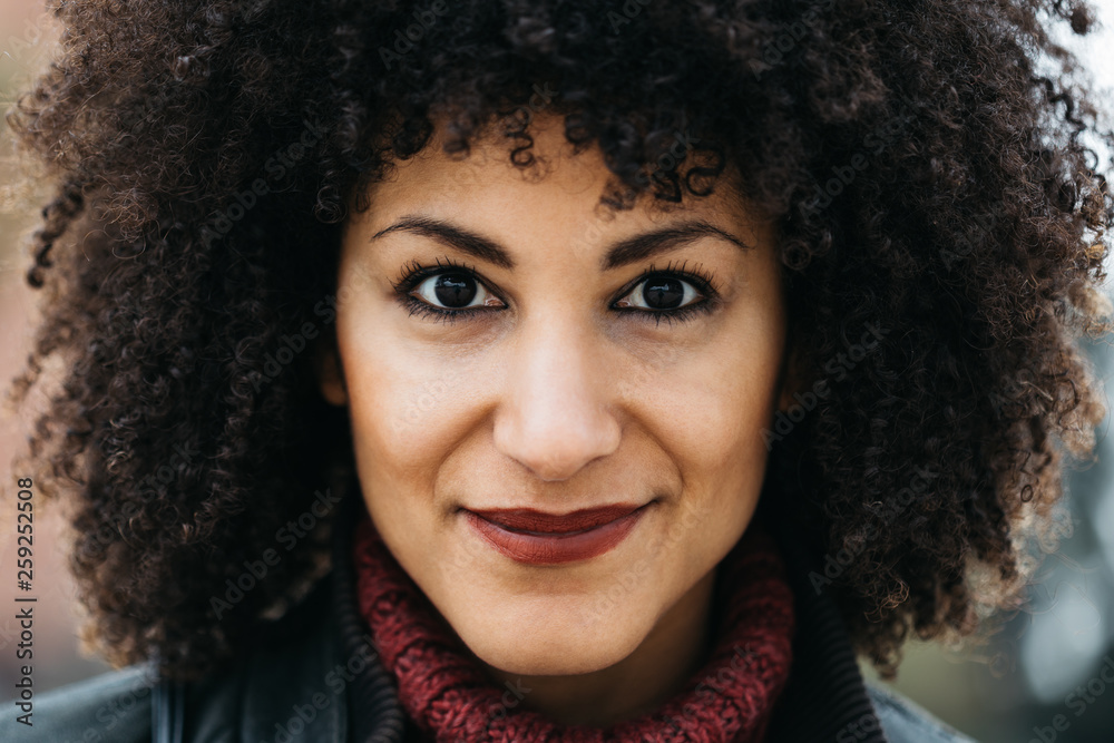 Beautiful smiling woman with frizzy hair looking at camera. Beautiful smiling woman with frizzy hair looking at camera.