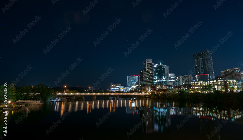 View of the Lamar Ave Bridge With Downtown Austin in the Background at Night