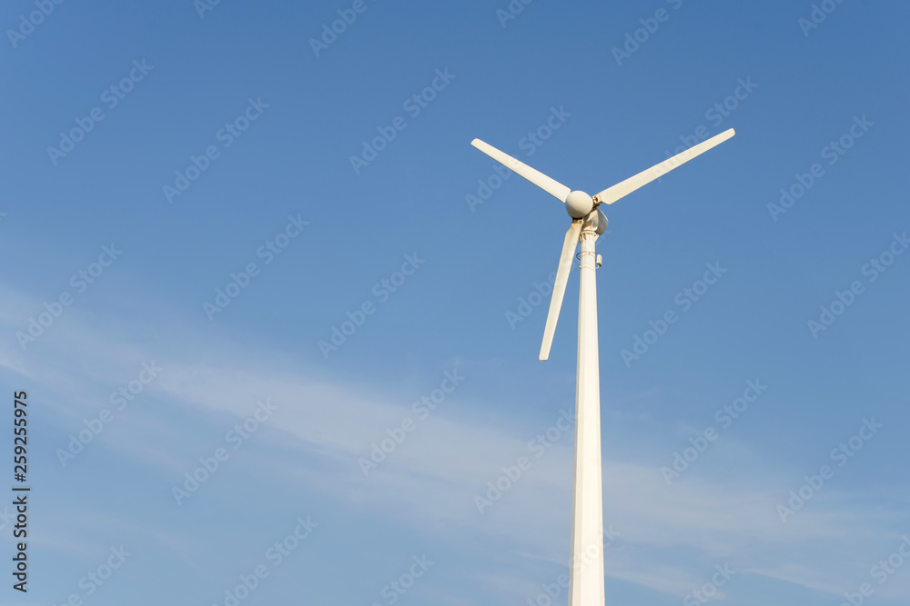 Wind turbine in front of blue cloudy sky. Energy conservation, generating electricity, Free copy space. Wind turbine in front of blue cloudy sky. Energy conservation, generating electricity, Free copy space.