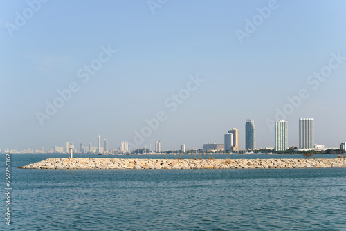 View on Pattaya city and sea from Ban Amphur beach. Buildings on the horizon. © evso