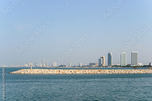 View on Pattaya city and sea from Ban Amphur beach. Buildings on the horizon.