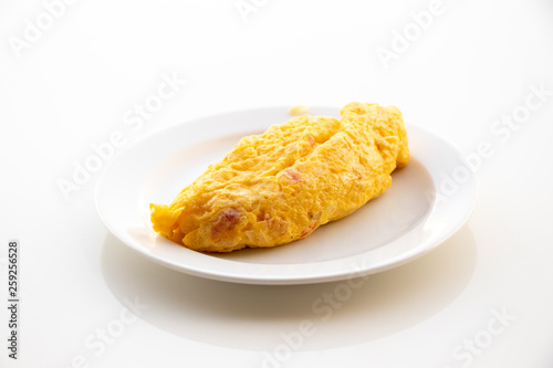 Egg omlet in dish place on white table background