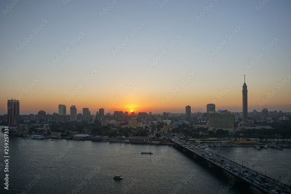 Cairo, Egypt: Cairo Tower and the Qasr el Nile Bridge at sunset. On Gezira Island in the River Nile, the tower is the tallest structure in Egypt.