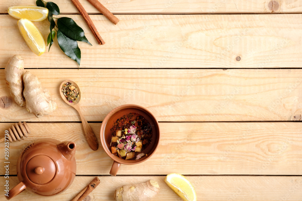 Flat lay composition of herbal tea, tea accessories, honey, spoon of dried tea, plant leaves, ginger root, lemon. Border frame, view from above, alternative medicine concept. Flat lay composition of herbal tea, tea accessories, honey, spoon of dried tea, plant leaves, ginger root, lemon. Border frame, view from above, alternative medicine concept.