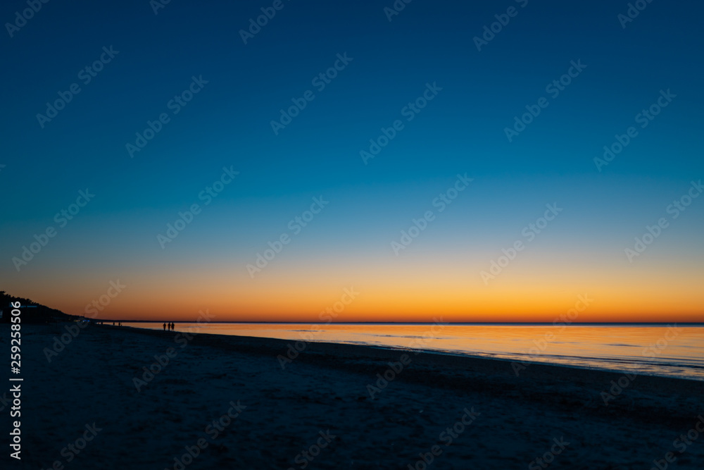 Vivid amazing sunset in Baltic States - Dusk in the sea with horizon illuminates by the sun