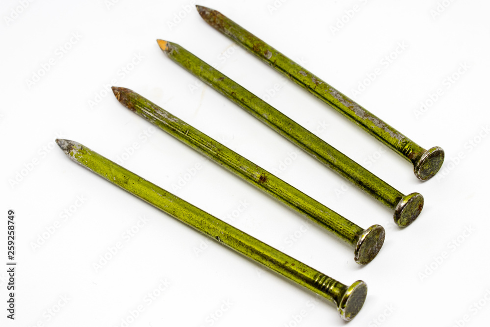 Fototapeta premium four old metal rusty nails closeup with white background