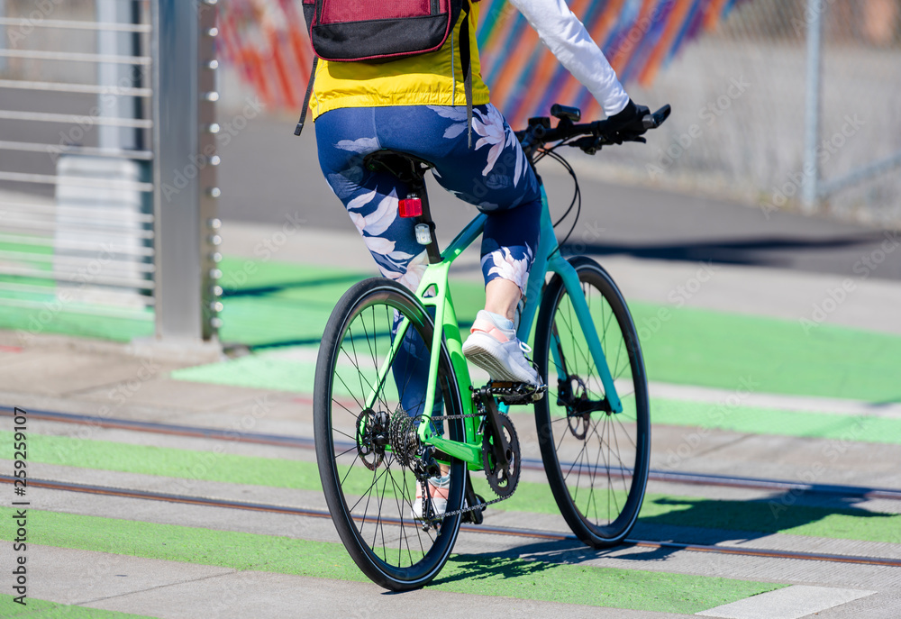 Fototapeta premium Elegant woman with backpack loves to ride bike taking care of her health