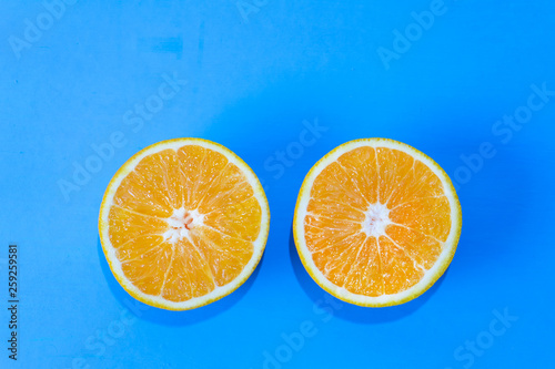 Orange halves on colorful background