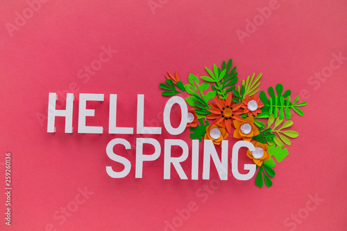 Hello Spring May hand lettering card. Spring tulip narcissus  plumeria paper craft flowers on dark pink background.